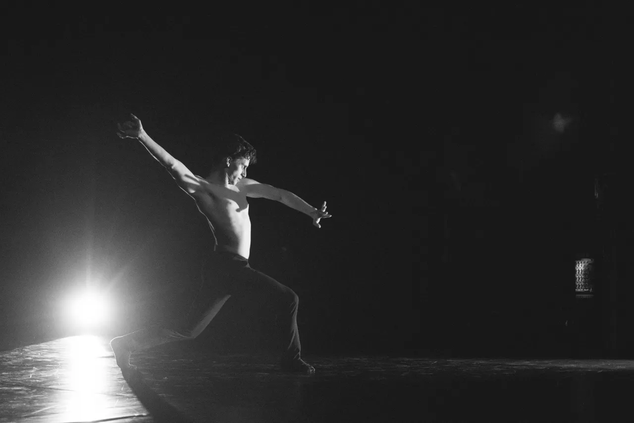 Tomás Pedro em palco, solo contemporâneo a contraluz